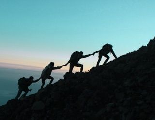 Hikers climb a mountain