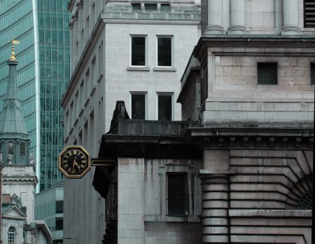 Older buildings in the foreground, modern glass front behind them